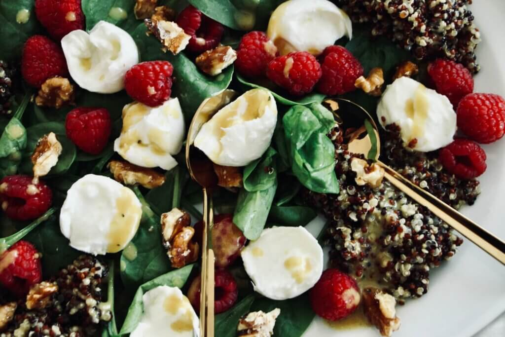Spinach and raspberry salad with caramelized nuts